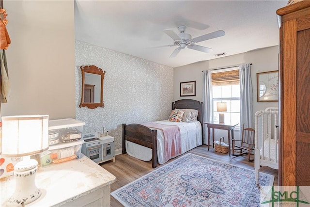 bedroom with ceiling fan and light hardwood / wood-style floors