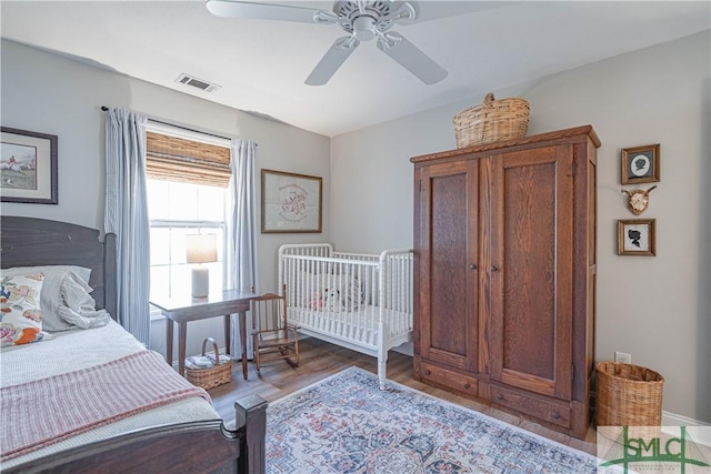 bedroom with ceiling fan and wood-type flooring