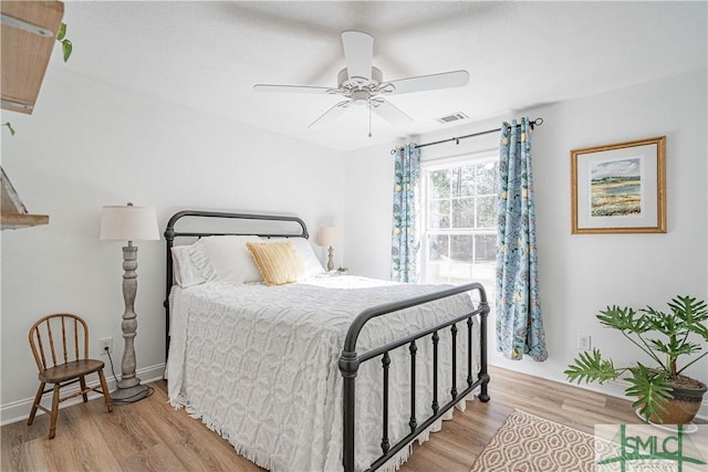 bedroom with ceiling fan and light hardwood / wood-style flooring