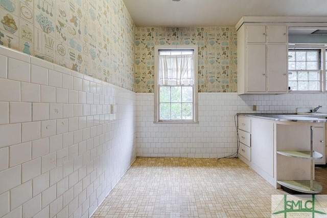 laundry room with tile walls and light tile patterned flooring