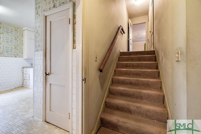 staircase with tile walls