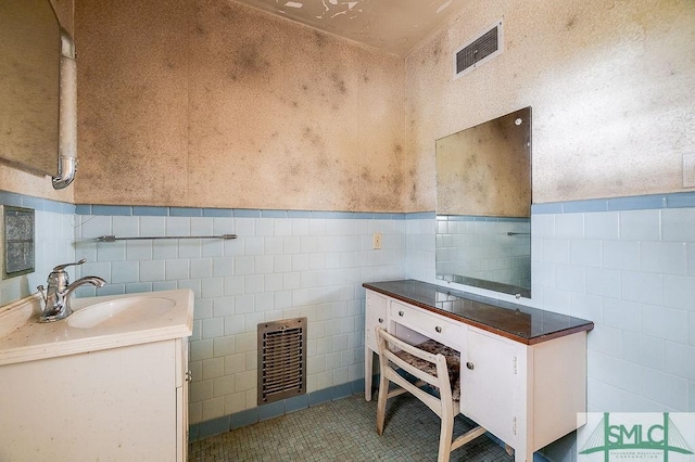 bathroom with sink, tile walls, heating unit, and tile patterned flooring