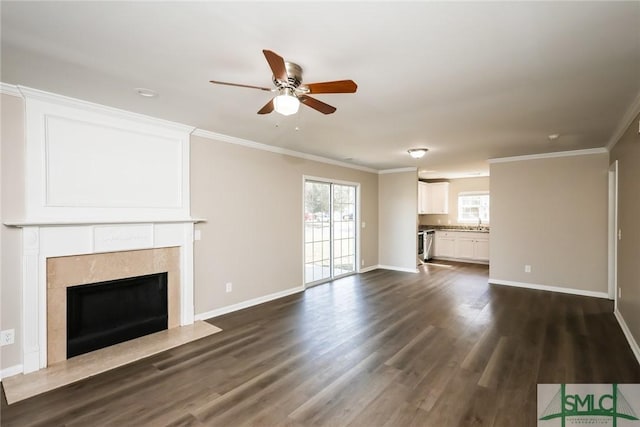 unfurnished living room with dark wood-style floors, baseboards, ornamental molding, and a high end fireplace