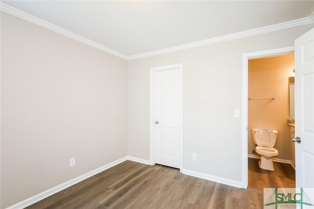 unfurnished bedroom with crown molding, wood finished floors, and baseboards