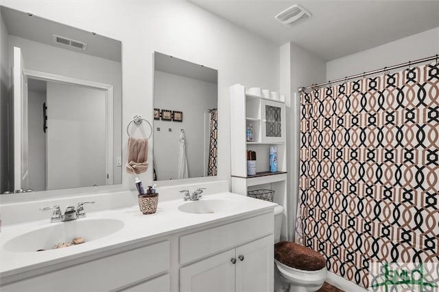 bathroom featuring vanity, toilet, and curtained shower