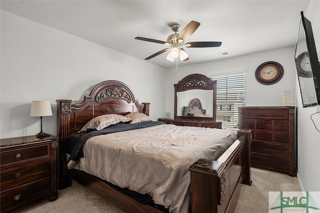 bedroom featuring light colored carpet and ceiling fan