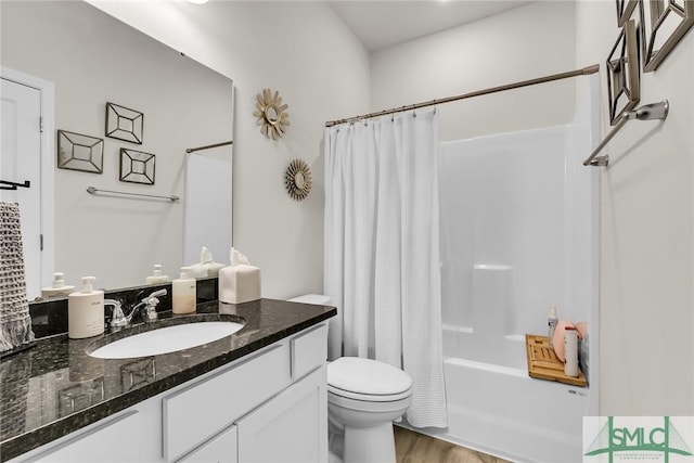 full bathroom featuring vanity, hardwood / wood-style flooring, shower / tub combo with curtain, and toilet