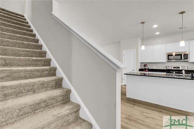 staircase featuring hardwood / wood-style floors