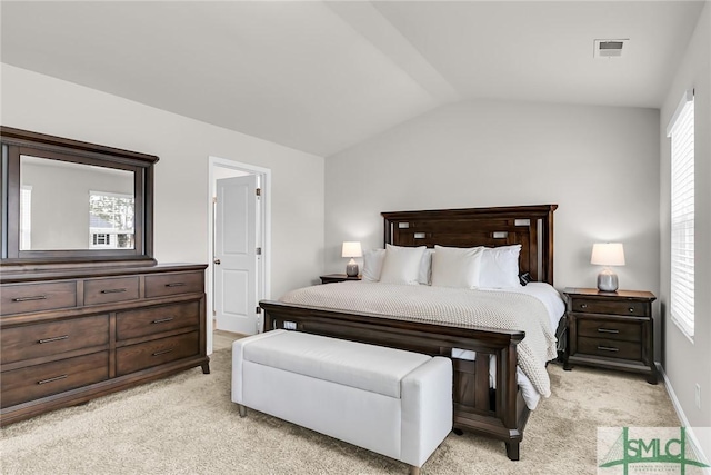 carpeted bedroom with lofted ceiling