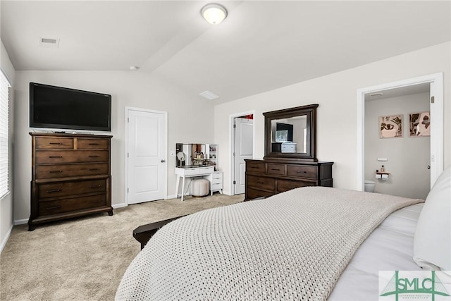 bedroom with vaulted ceiling and light carpet