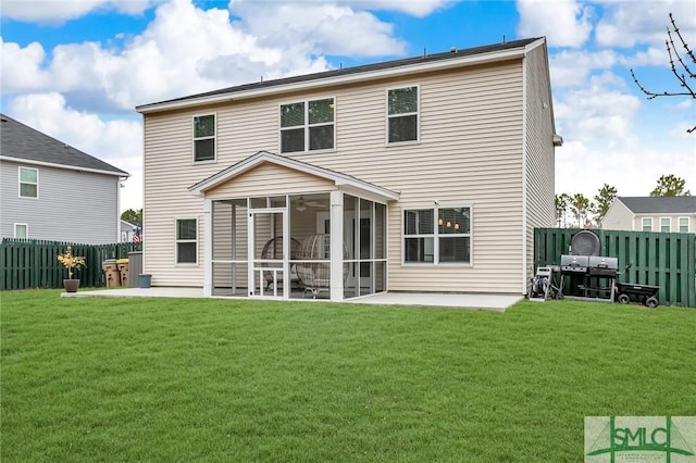 rear view of house with a sunroom, a lawn, and a patio