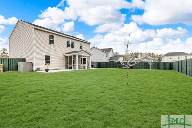 back of house with a patio area, a yard, and a sunroom