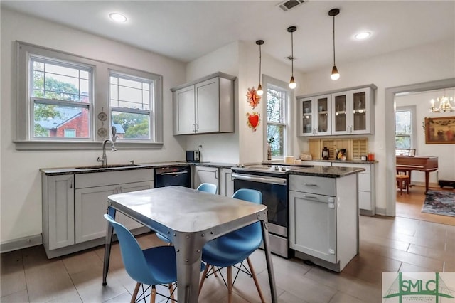 kitchen with a center island, gray cabinetry, stainless steel range with electric stovetop, sink, and pendant lighting