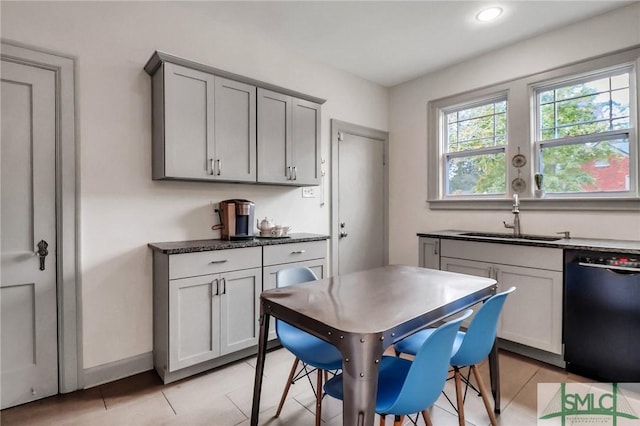 kitchen featuring sink, black dishwasher, light tile patterned floors, and gray cabinetry