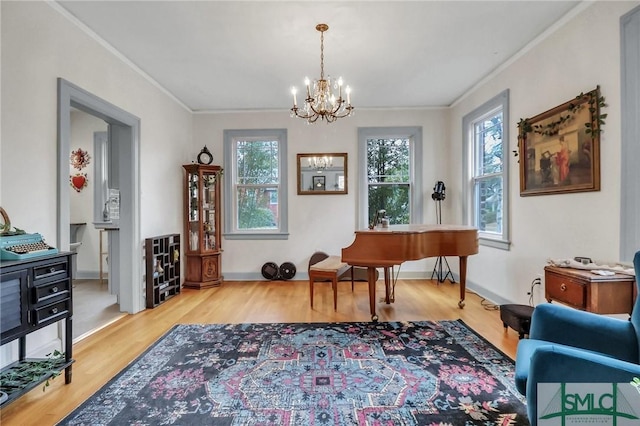 sitting room featuring a notable chandelier, crown molding, and light hardwood / wood-style floors