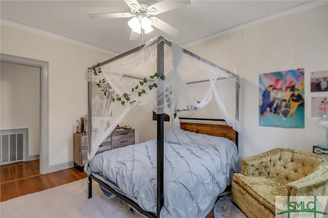 bedroom featuring hardwood / wood-style floors, ceiling fan, and ornamental molding