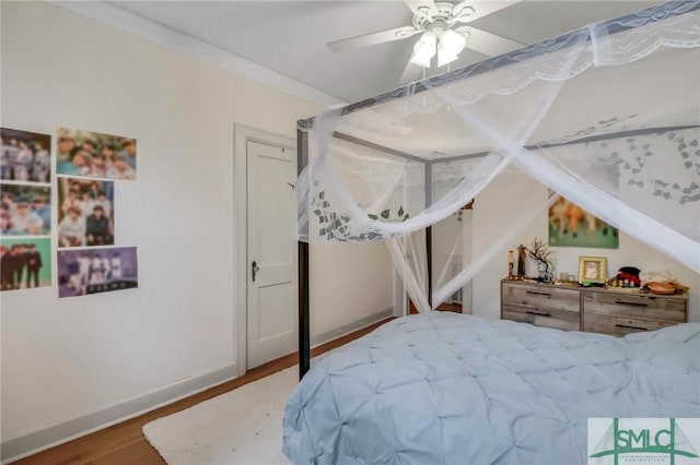 bedroom with ceiling fan, crown molding, and hardwood / wood-style flooring