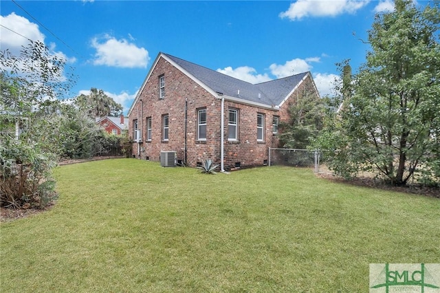 view of home's exterior featuring a yard and central AC