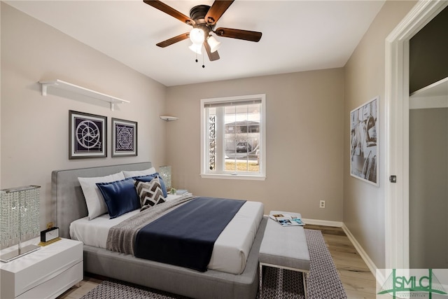 bedroom with ceiling fan and light hardwood / wood-style flooring