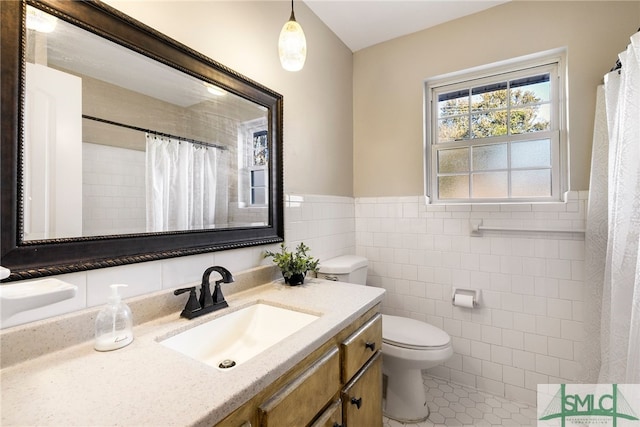 bathroom with tile patterned floors, vanity, a shower with curtain, tile walls, and toilet