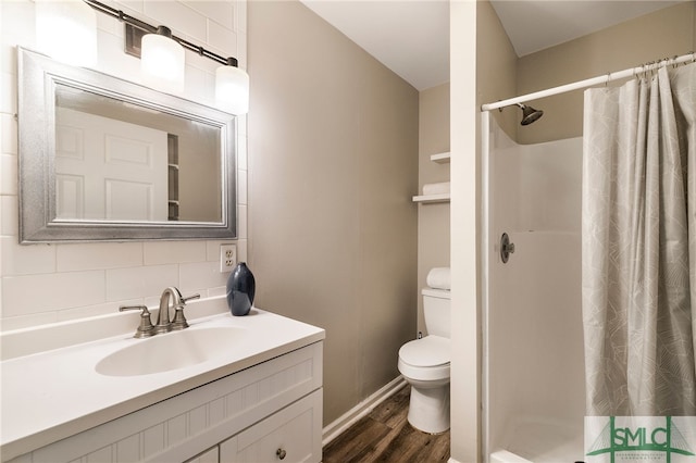 bathroom featuring hardwood / wood-style floors, decorative backsplash, walk in shower, and vanity