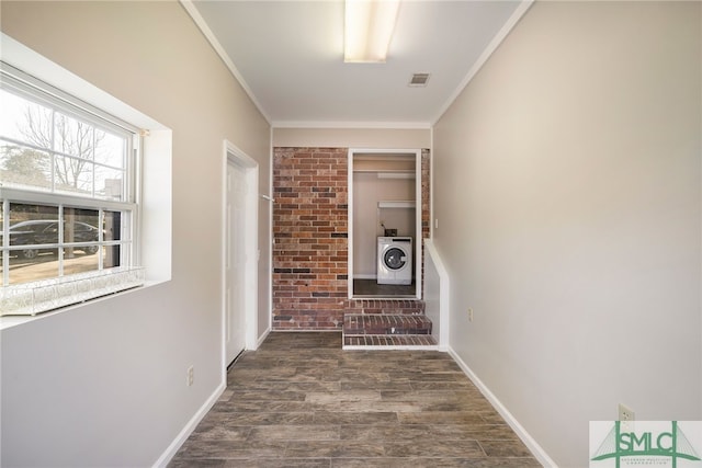 hall with ornamental molding, dark hardwood / wood-style floors, and washer / dryer