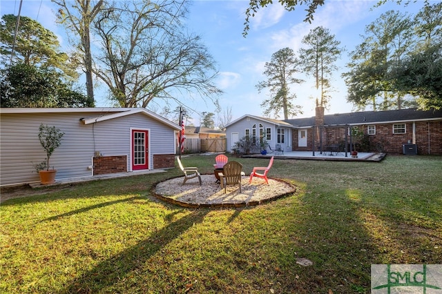 view of yard featuring an outdoor fire pit and a patio