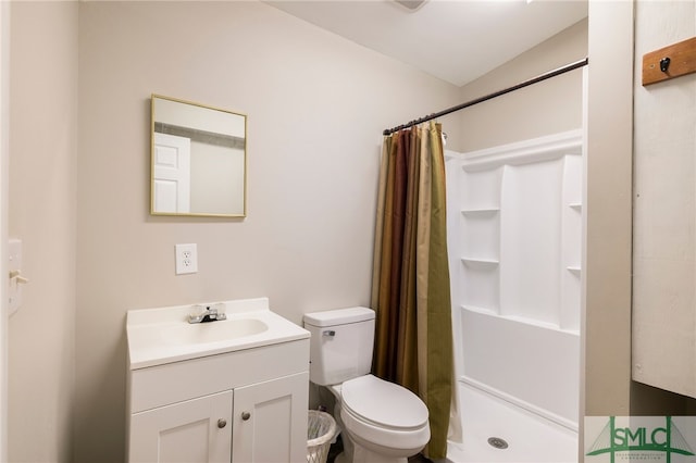 bathroom featuring a shower with curtain, toilet, and vanity