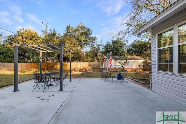 view of patio featuring a pergola and a shed