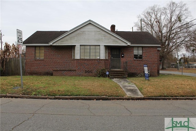 bungalow-style home featuring a front yard