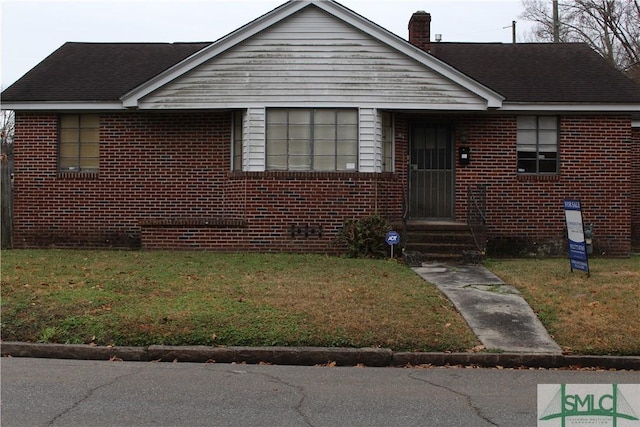 bungalow-style house with a front yard