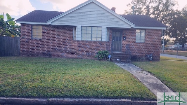 bungalow-style home featuring a lawn