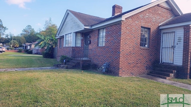 view of side of property with a yard