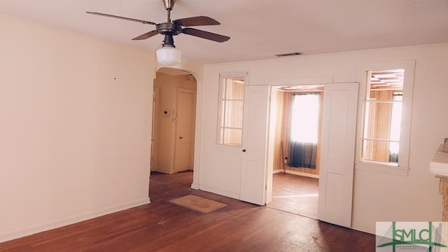 spare room with ceiling fan and dark hardwood / wood-style floors