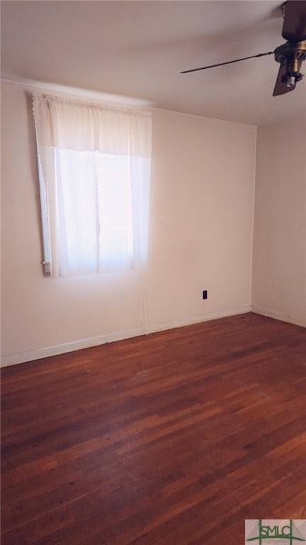 unfurnished room featuring ceiling fan and dark wood-type flooring