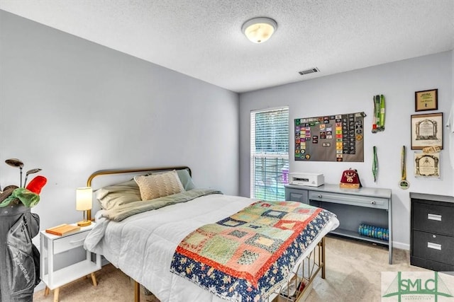 carpeted bedroom featuring a textured ceiling