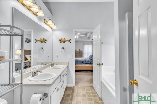 bathroom with vanity, a bathtub, and ceiling fan