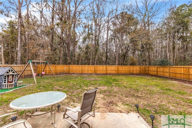 view of yard featuring a playground and a patio