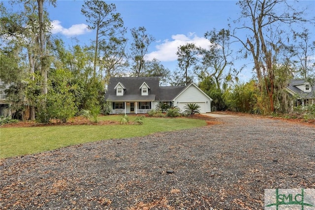 view of front facade featuring a garage, a front yard, and covered porch