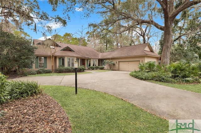 ranch-style home featuring a garage and a front lawn