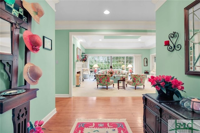 interior space with crown molding and light hardwood / wood-style floors