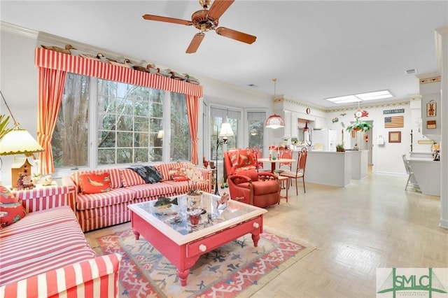 living room featuring ceiling fan, crown molding, and light parquet floors