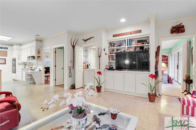 living room featuring light parquet flooring, ornamental molding, and built in features