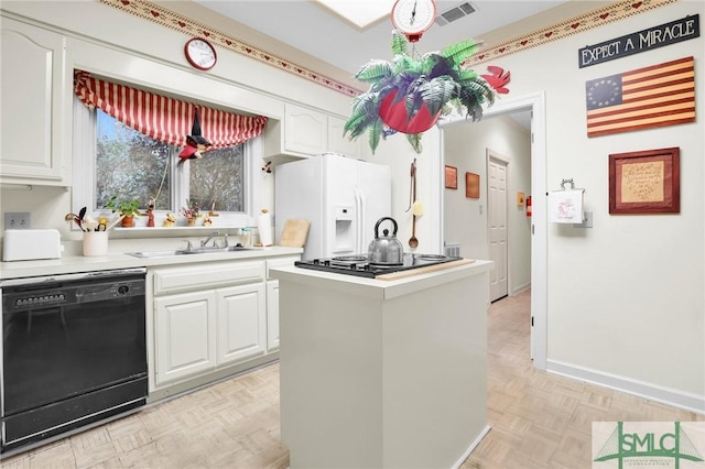 kitchen with white cabinetry, sink, and black appliances