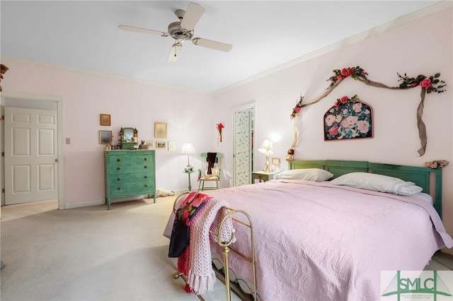 carpeted bedroom featuring ornamental molding and ceiling fan