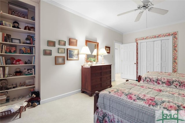 carpeted bedroom with ceiling fan, ornamental molding, and a closet