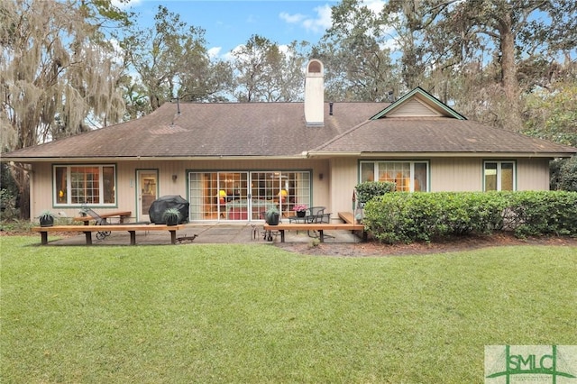 back of house with a lawn