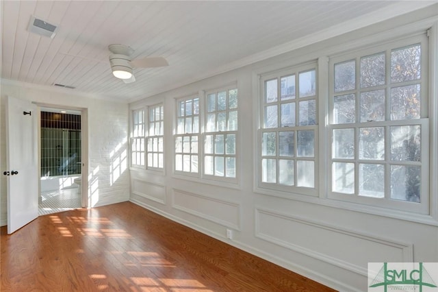 unfurnished sunroom featuring wooden ceiling and ceiling fan