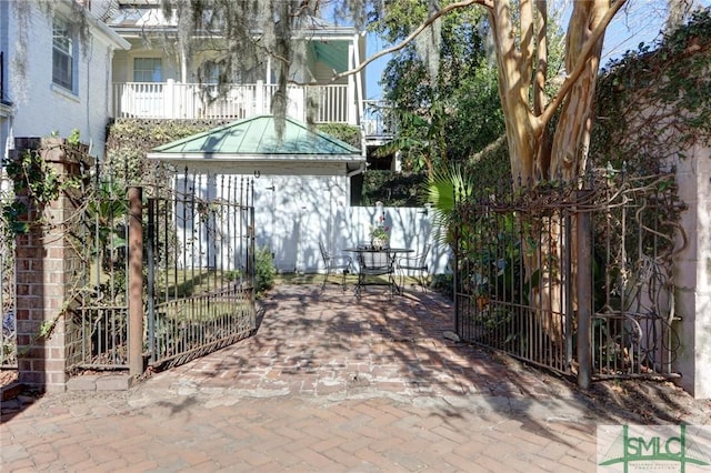 view of patio featuring a balcony