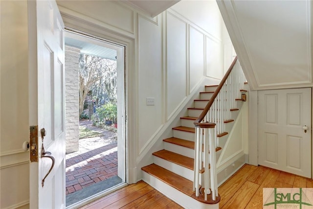 stairs featuring wood-type flooring